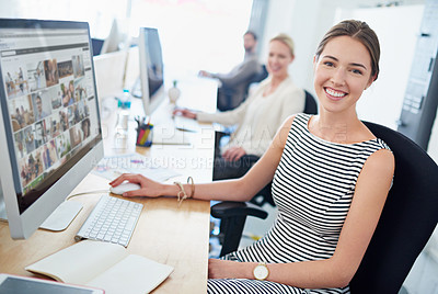 Buy stock photo Portrait of a young office worker sitting at her workstation in an office