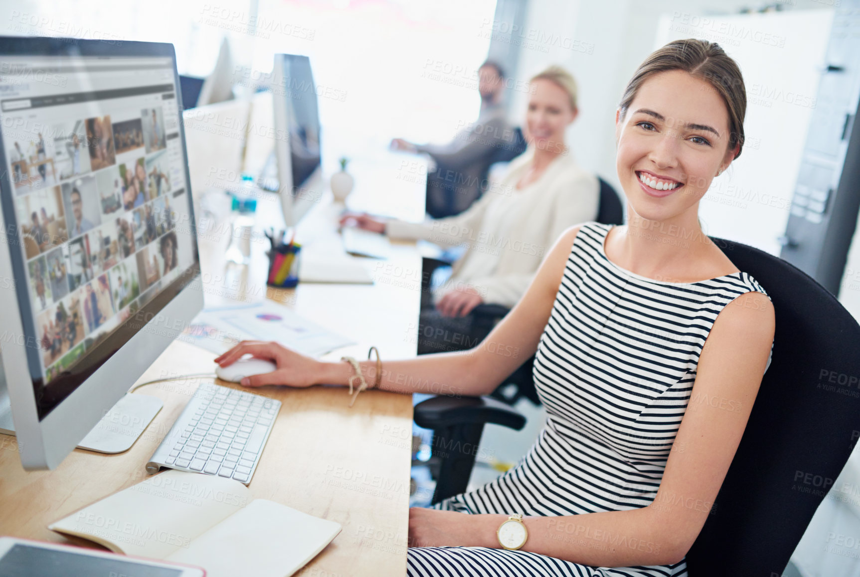 Buy stock photo Portrait of a young office worker sitting at her workstation in an office