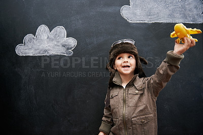 Buy stock photo Child, boy and happy by blackboard with plane for creative fun, playing and drawing of clouds for education. Student, kid and confidence with airplane, chalkboard or illustration for knowledge or sky