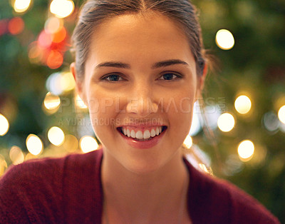 Buy stock photo Portrait of a beautiful young woman in front of a christmas tree