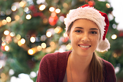 Buy stock photo Christmas, woman and happy holiday portrait with cheerful smile at festive tree in home. Christmas tree, happiness and excited girl in home for vacation celebration with red santa hat.


