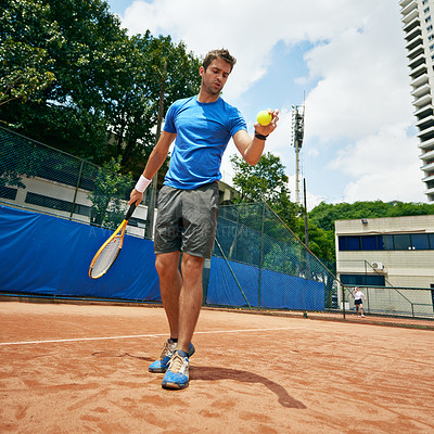 Buy stock photo Shot of a tennis player getting ready to serve
