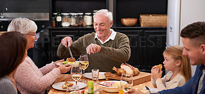Buy stock photo Happy family, drinks and food at table for celebration, thanksgiving and bonding time. Grandfather, dining room and dinner for supper, feast meal and share at home with grandparents for holiday