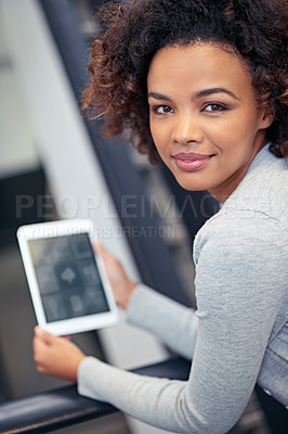 Buy stock photo Portrait of an attractive young woman holding a digital tablet 