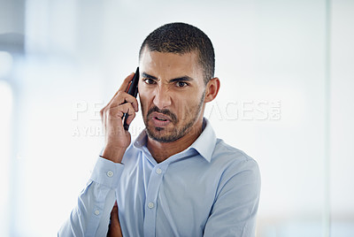 Buy stock photo Cropped shot of a handsome young businessman using in cellphone in the office