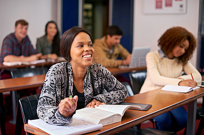 Buy stock photo Shot of a happy student paying attention in class