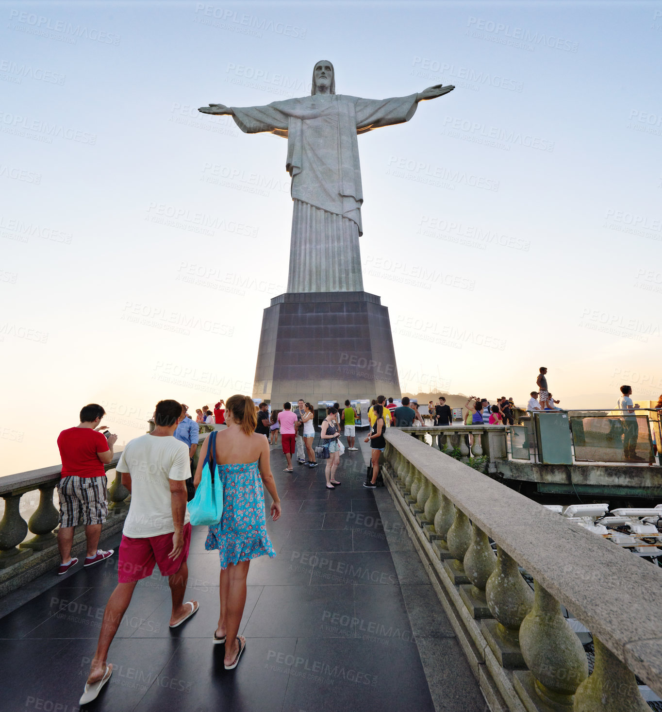 Buy stock photo People, christ and statue with tourist in rio de Janeiro of redeemer for sightseeing, landmark or view of sculpture. Group, community or crowd on tour, trip or monument of iconic attraction in Brazil