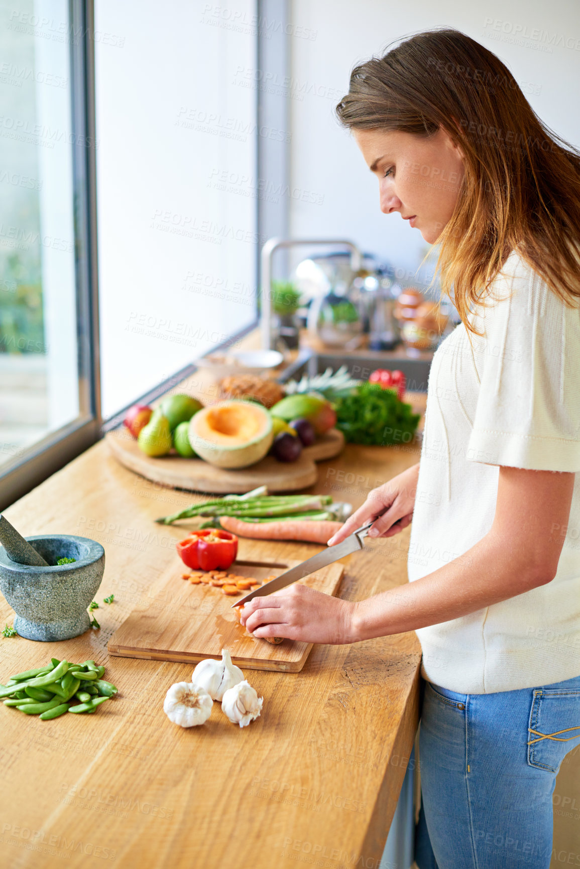 Buy stock photo Vegan, home and woman with vegetables, cutting and food with healthy meal, hobby and nutrition. Organic ingredients, vegetarian and person in kitchen, wellness and chef with skills, cooking and diet