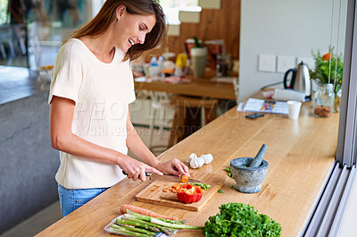 Buy stock photo Cooking, kitchen and happy woman with healthy food, meal prep and cutting fresh vegetables for lunch. Diet, wellness and female person in home with ingredients, nutrition and dinner in apartment.