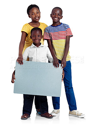 Buy stock photo Studio shot of three african siblings with a blank board against a white background