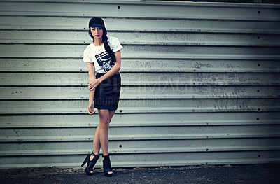 Buy stock photo Portrait of a stylishly dressed young woman standing in front of a metal wall