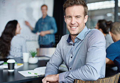 Buy stock photo Portrait of an office worker with his colleagues sitting in the background