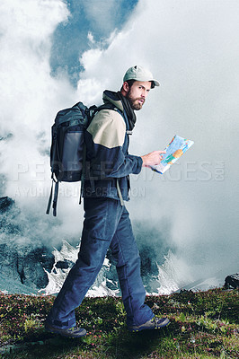 Buy stock photo Shot of a male hiker in extreme terrain using his map as he walks