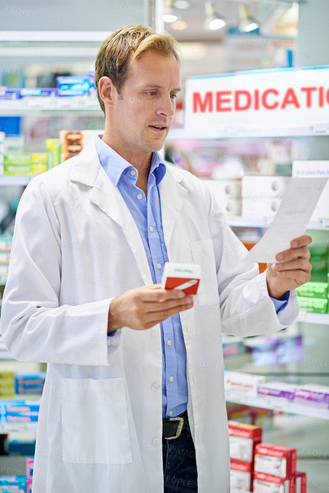 Buy stock photo A pharmacist reading a prescription