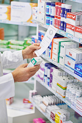 Buy stock photo A pharmacist reading a prescription