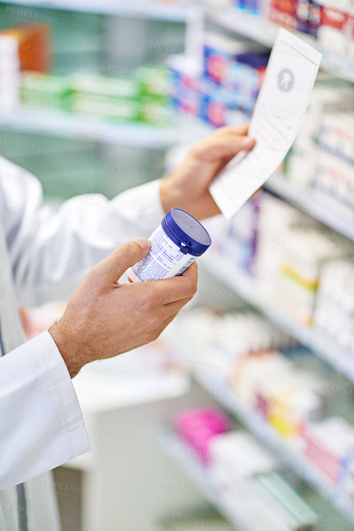 Buy stock photo A pharmacist reading a prescription