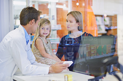 Buy stock photo Pharmacist, woman and child with medicine in store for healthcare, wellness and smile with advice. Pills, mother and daughter with box, supplements and discount for pharmaceutical product at shop