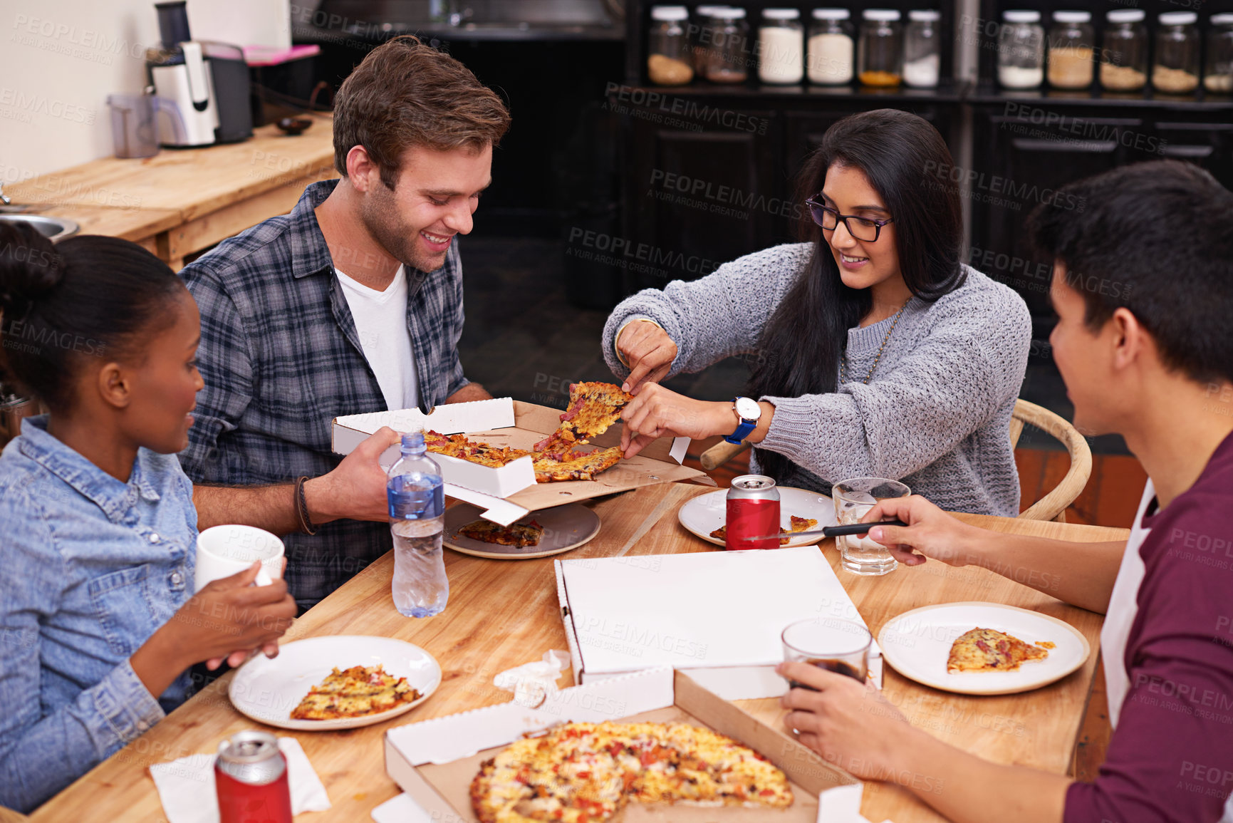 Buy stock photo Cropped shot of a group of friends enjoying pizza together