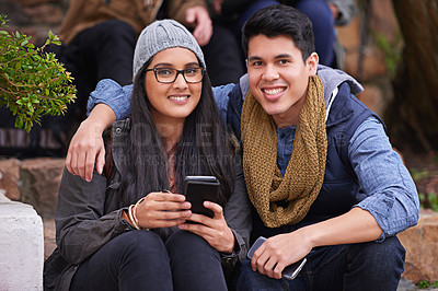 Buy stock photo Students, couple and portrait on campus with smile, smartphones and happiness at college. Man, woman and hug at university for bonding, support and care together and sit on steps on school grounds