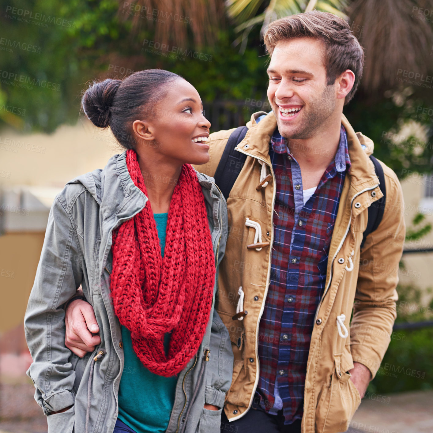 Buy stock photo Study, couple and walking together with love, happiness and pride outdoor at university. Man, woman and interracial college students on campus with smile for relationship, memories and romance
