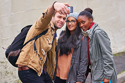 Buy stock photo Cropped shot of a group of college students taking a selfie on campus