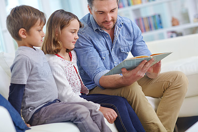 Buy stock photo Education, learning or reading with father and children on sofa in living room together for bonding or study. Book, literature or storytelling with dad and kids in apartment for development or growth