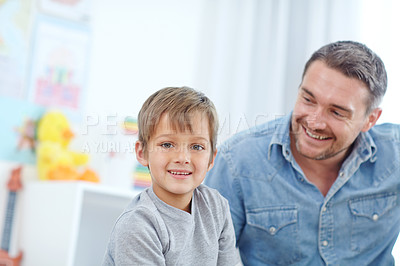 Buy stock photo Portrait of a happy father and son spending time together at home