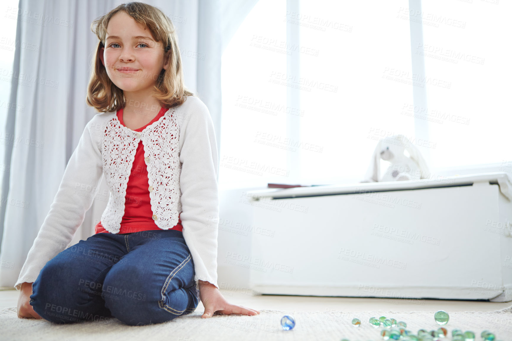 Buy stock photo Shot of an adorable little girl playing marbles at home