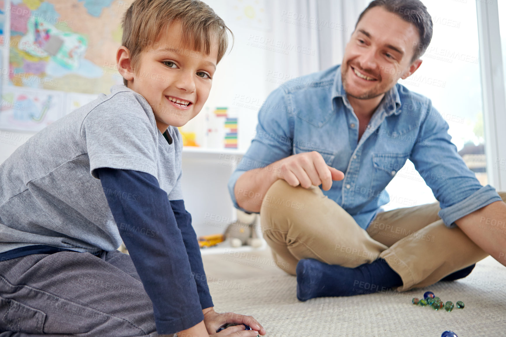 Buy stock photo Portrait of a happy father and son playing marbles together at home