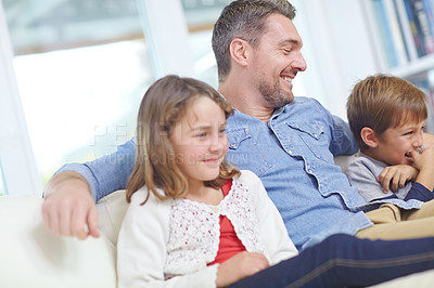 Buy stock photo Shot of of a happy father relaxing on the sofa with his son and daughter