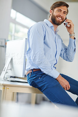 Buy stock photo A handsome male designer talking on his phone