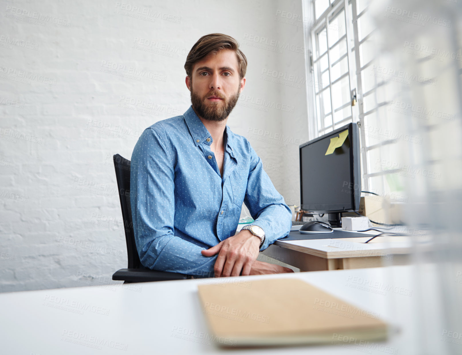 Buy stock photo Portrait of a serious designer in his office