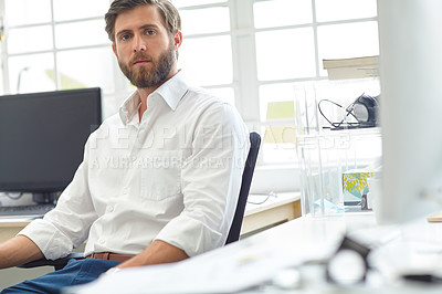 Buy stock photo Portrait of a serious designer sitting in his office
