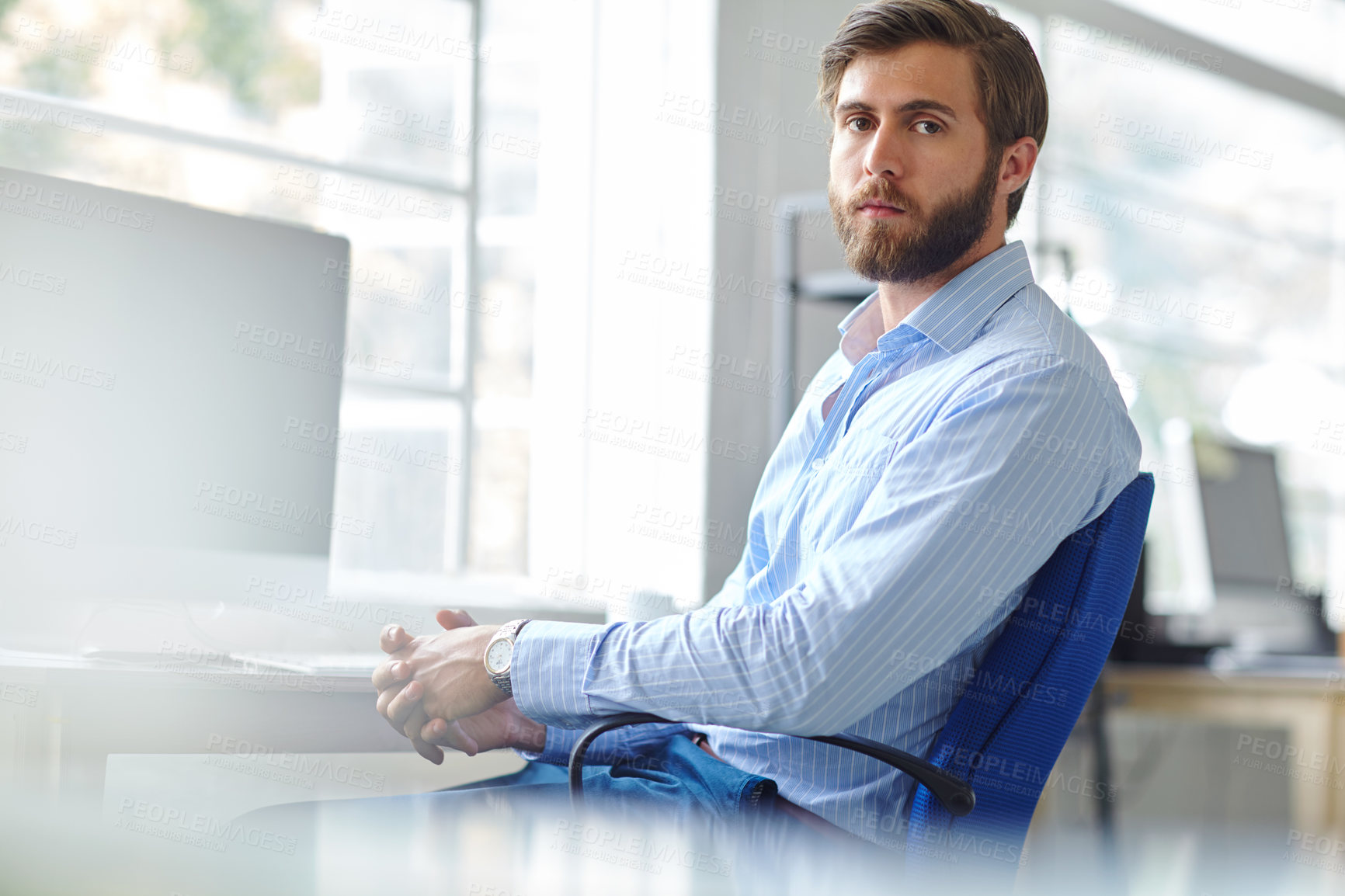 Buy stock photo Portrait of a handsome designer sitting on an office chair