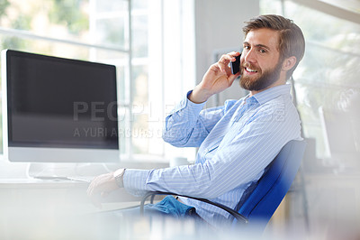 Buy stock photo Shot of a handsome designer talking on his phone at the office