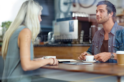 Buy stock photo Shot of a young couple on a date at a coffee shop