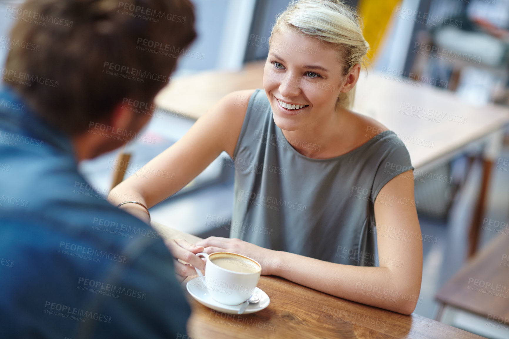 Buy stock photo Over the shoulder shot of a beautiful young woman on a coffee date with her boyfriend