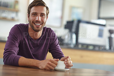 Buy stock photo Portrait of a handsome young man having coffee at a cafe