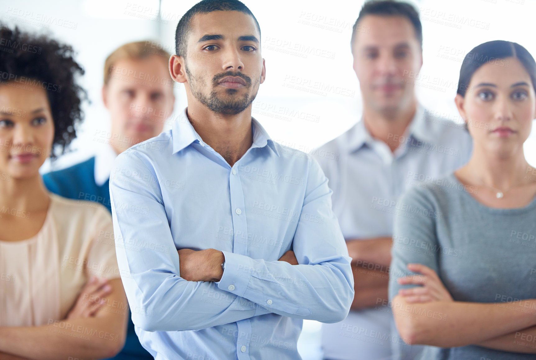 Buy stock photo Portrait of a handsome young business man with his colleagues in the background