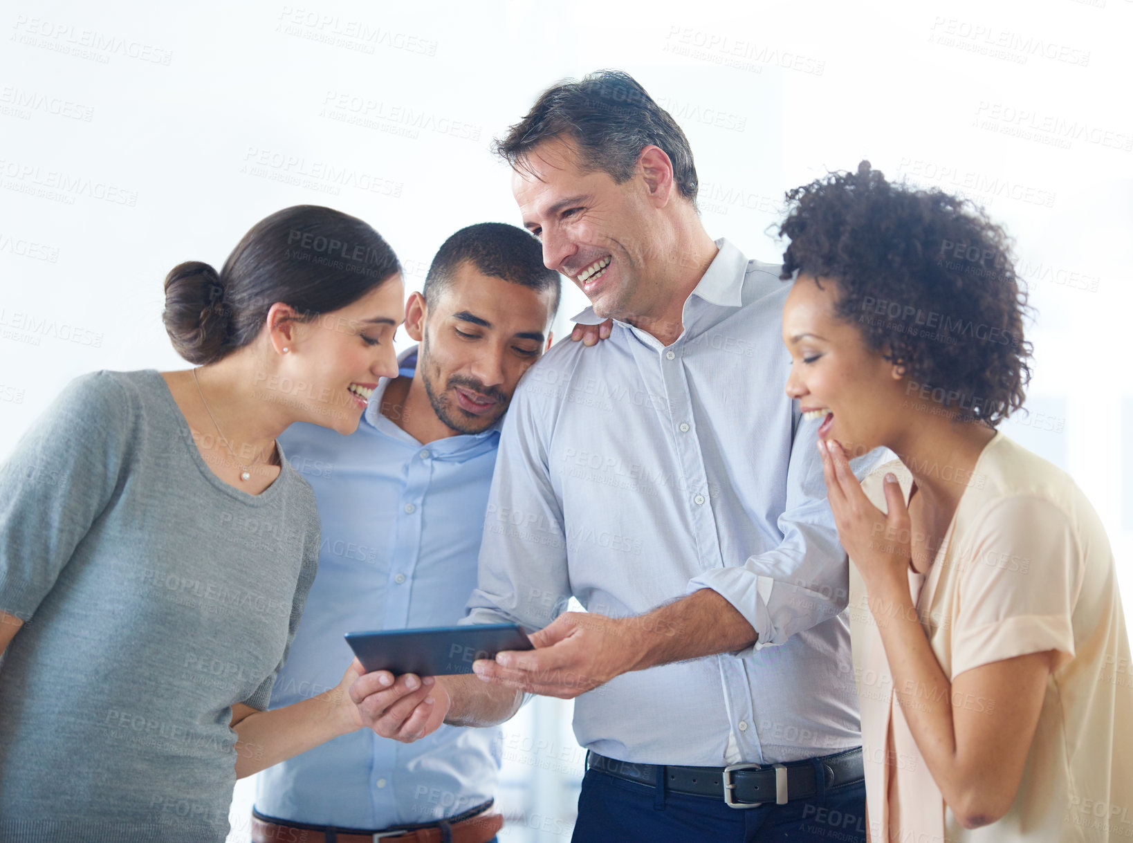 Buy stock photo Shot of a group of colleagues using a digital tablet together in an office