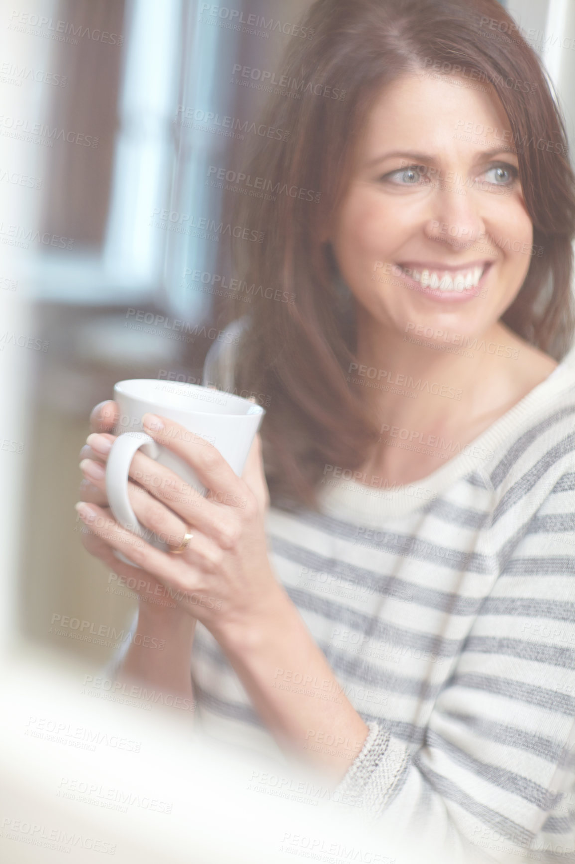 Buy stock photo Shot of a beautiful woman enjoying a cup of coffee at home