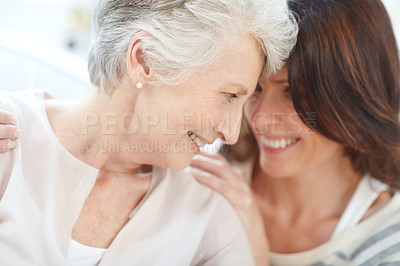 Buy stock photo Shot of an affectionate mother and daughter spending time together at home