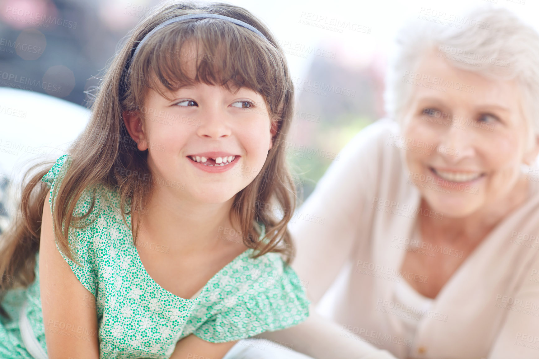 Buy stock photo Shot of a loving grandmother and granddaughter spending time together at home