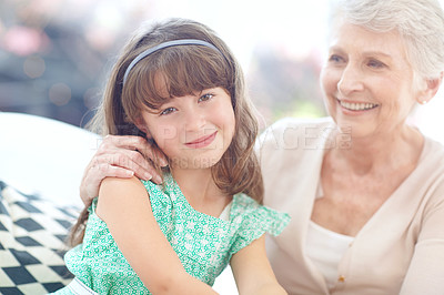 Buy stock photo Portrait of a loving grandmother and granddaughter spending time together at home