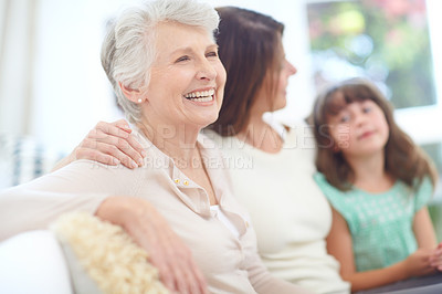 Buy stock photo Shot of an elderly woman spending time with her daughter and granddaughter at home