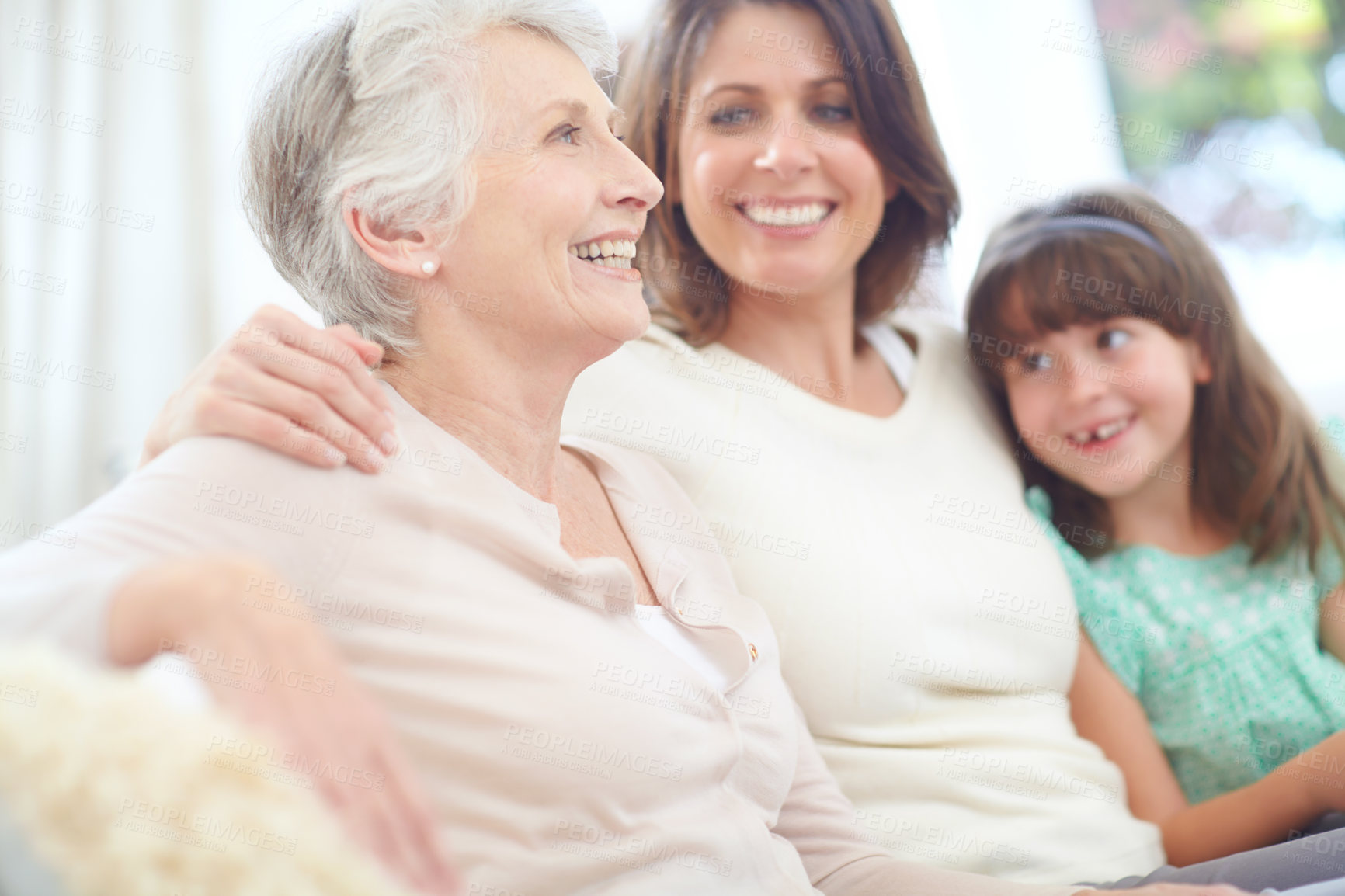 Buy stock photo Happy, relax and senior woman with family on sofa in living room for bonding together at home. Smile, rest and elderly female person with daughter and grandchild for generations connection at house.