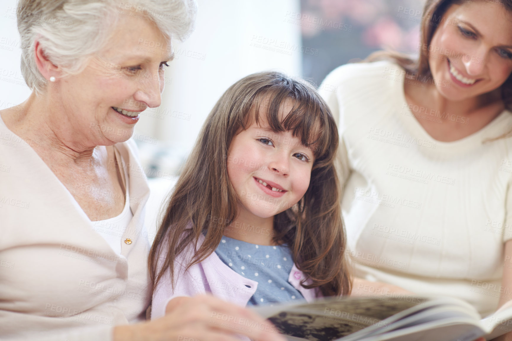 Buy stock photo Portrait, book and kid with mom and grandmother on sofa in living room for bonding together. Happy, relax and girl with mother and senior woman reading fantasy story, novel or literature at home.