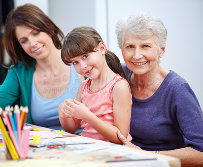 Buy stock photo Shot of a little girl and her mother and grandmother being creative together