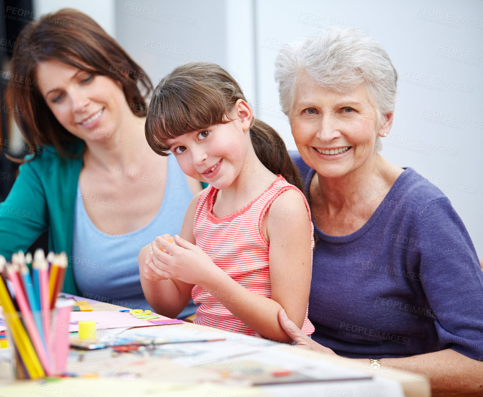 Buy stock photo Shot of a little girl and her mother and grandmother being creative together