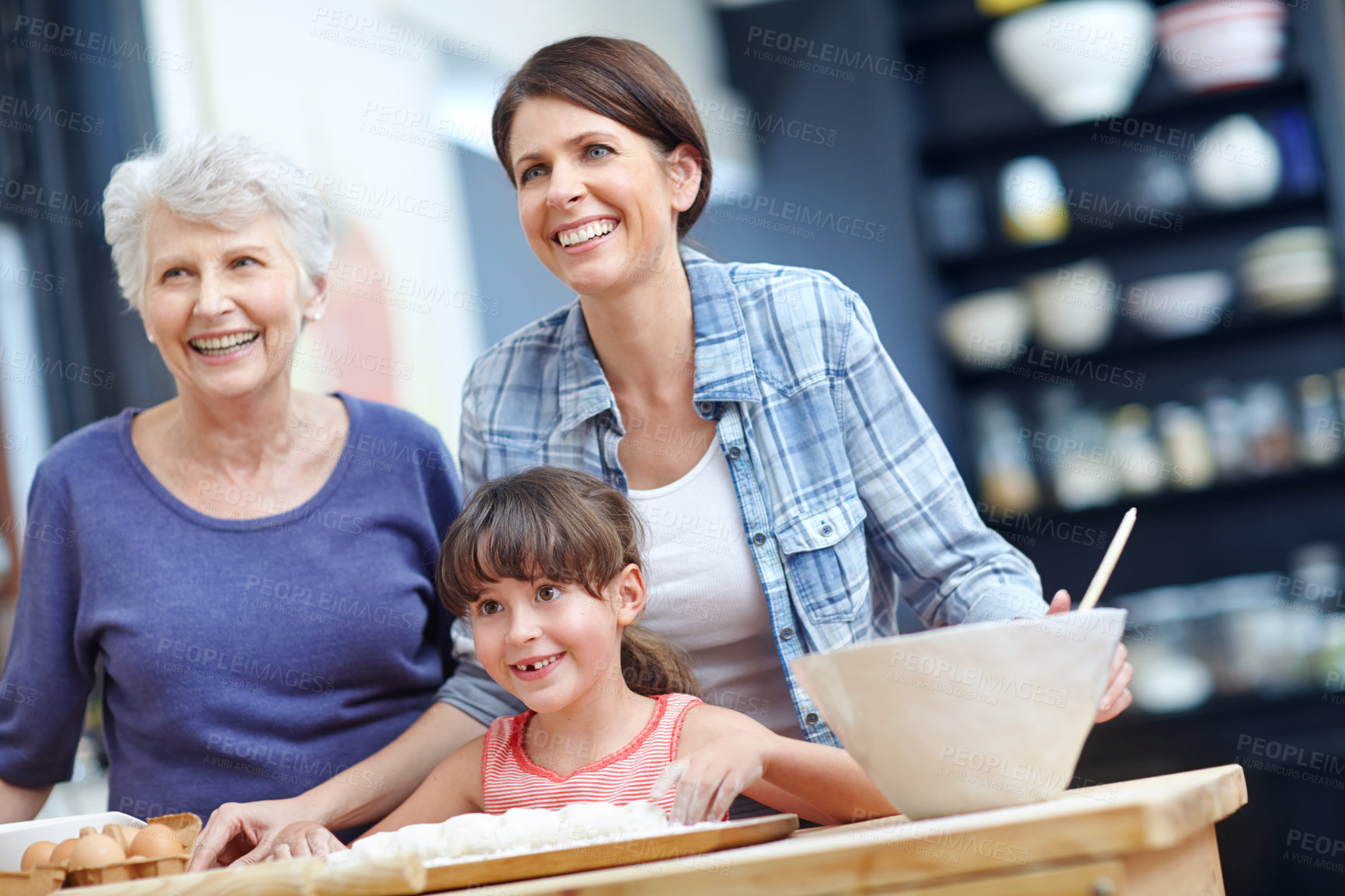 Buy stock photo Shot of a three generational family baking together